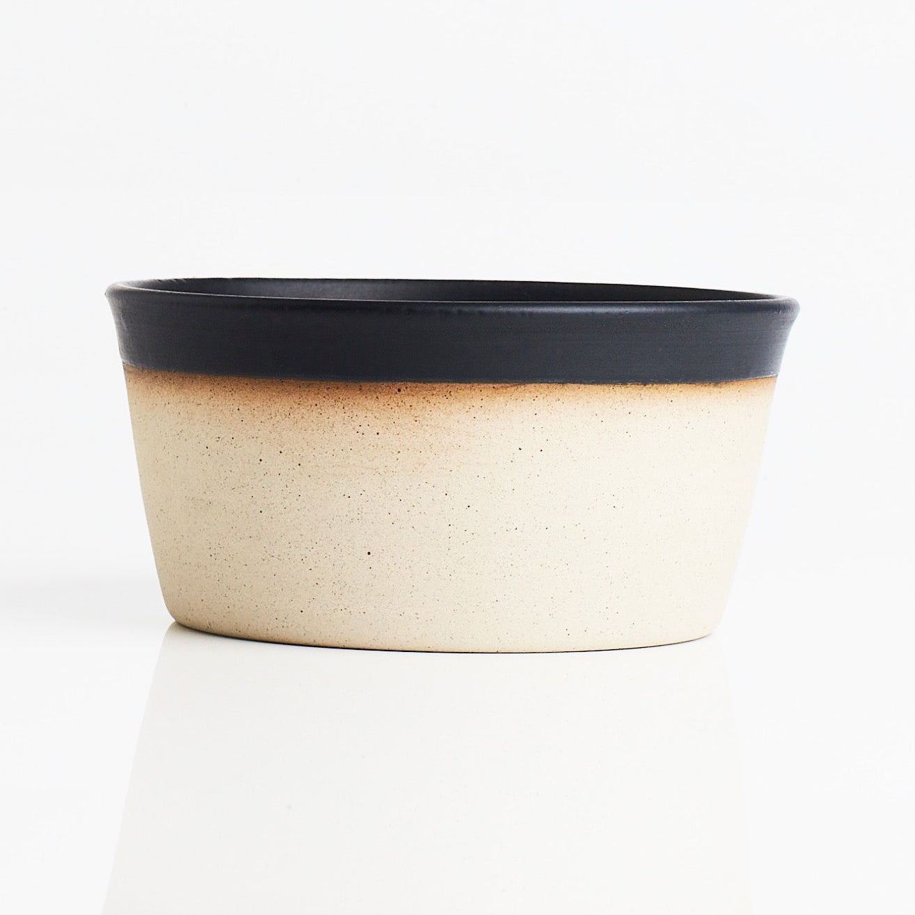 ceramic dog bowl with black rim on whits background
