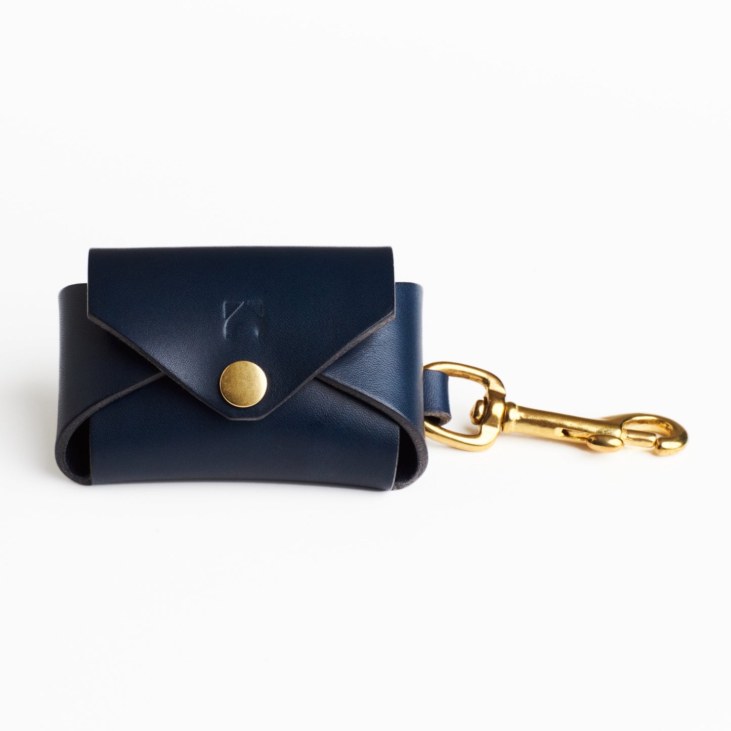 Midnight Blue leather poop bag holder with solid brass eyelet dispenser and clip on a white background