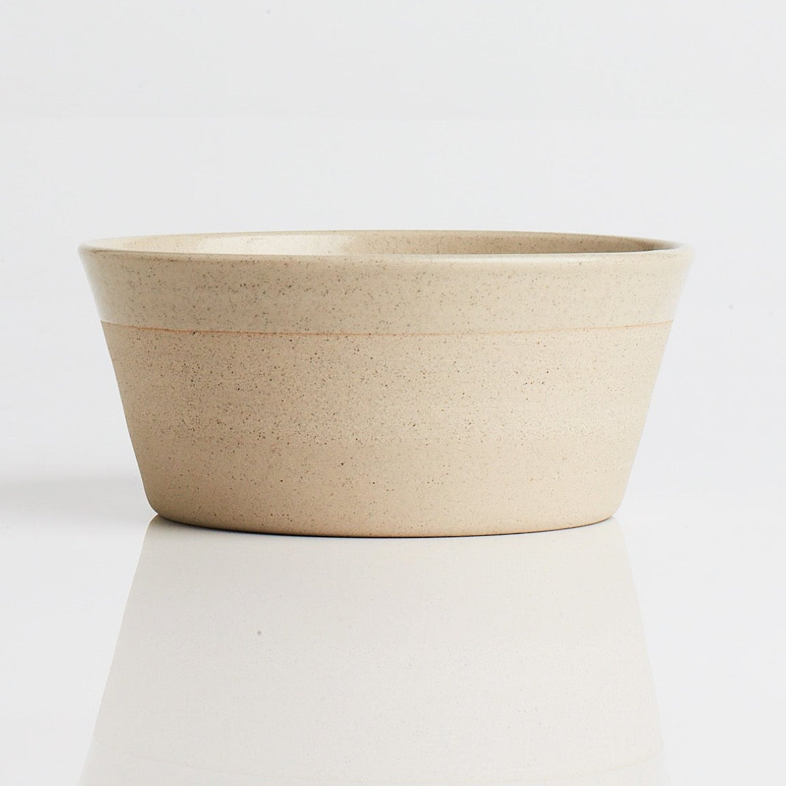 Sandstone dog food bowl on a white background