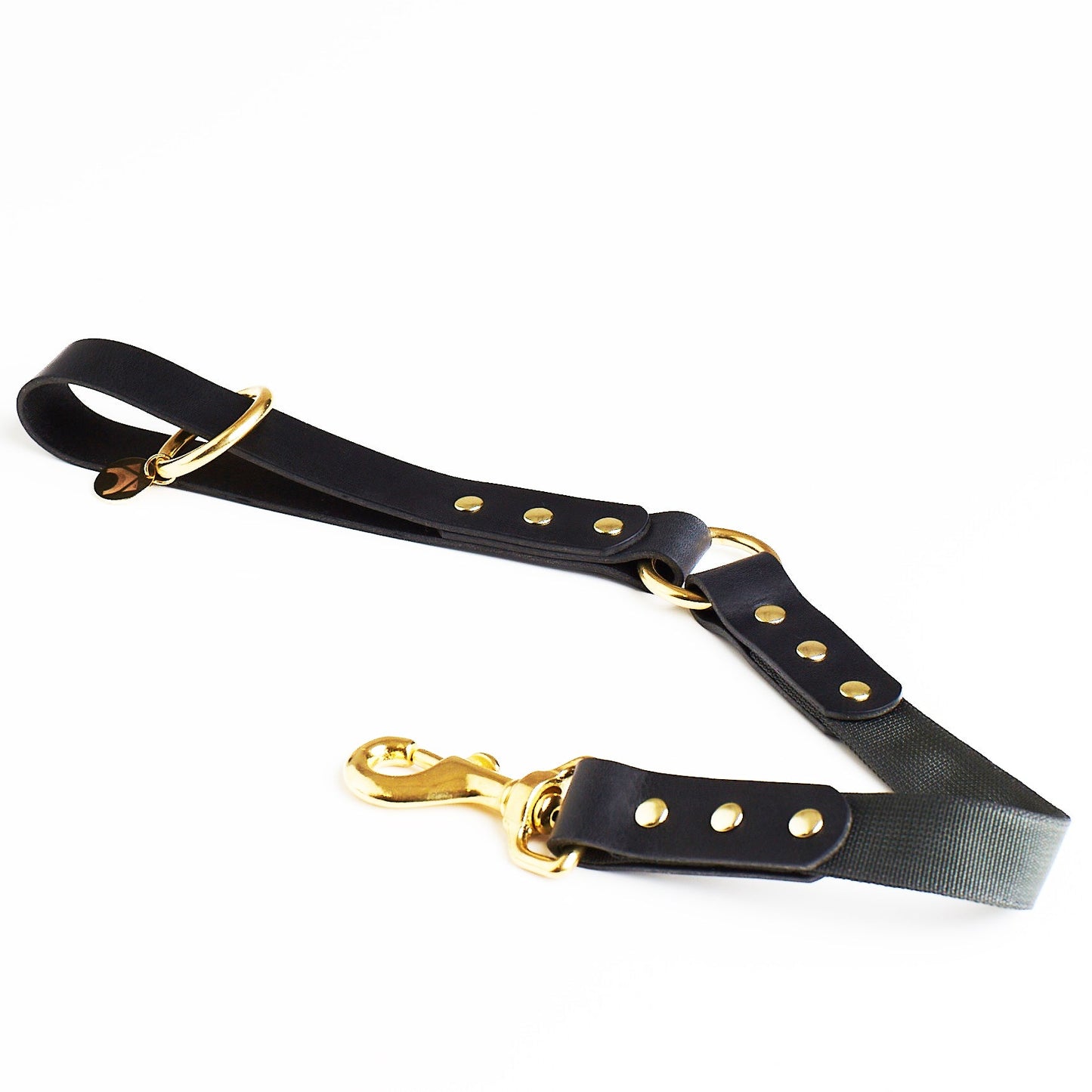 black leather and slate grey webbing dog lead with brass hardware on a white background